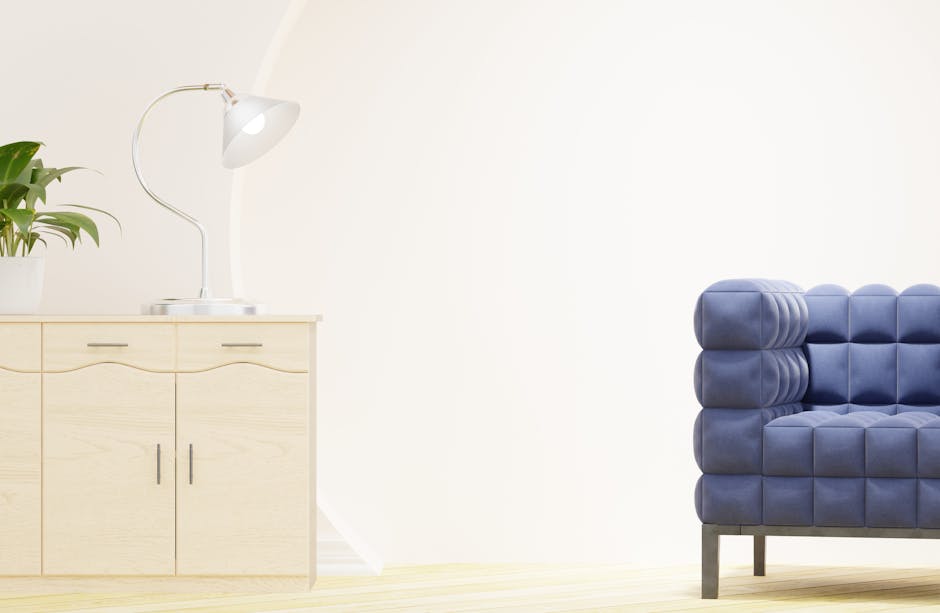 Bright modern living room featuring a stylish blue sofa and light wood cabinet with decor.