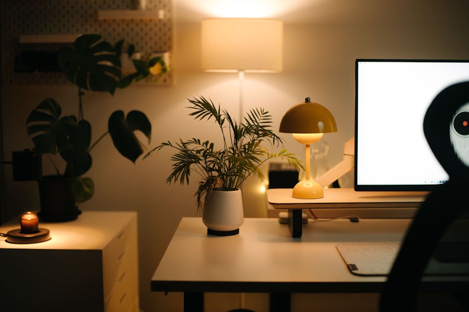 A warm and cozy home office setup with ambient lighting and plants, perfect for work-from-home environments.