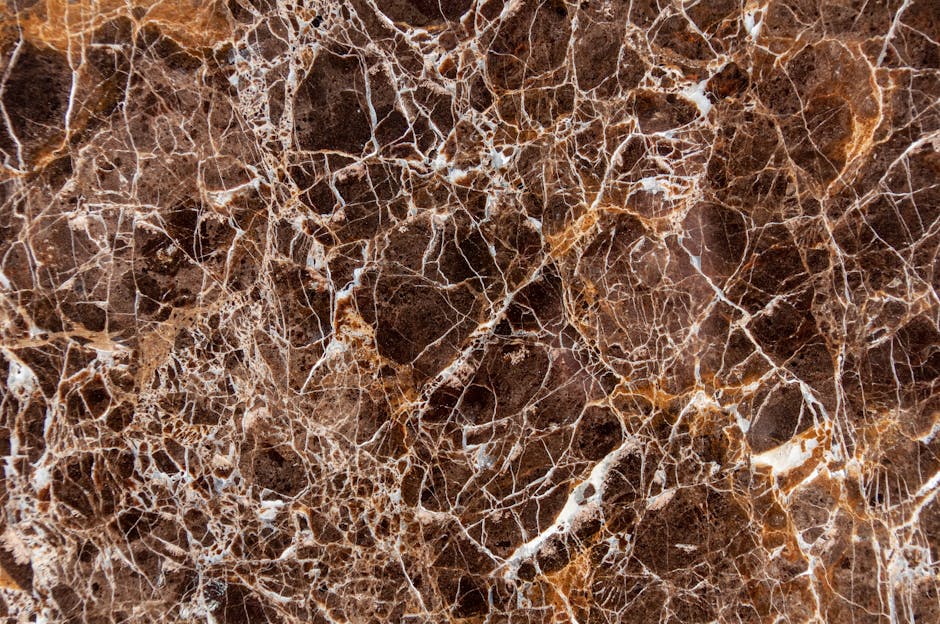 Close-up view of detailed brown marble texture with intricate patterns and veins.