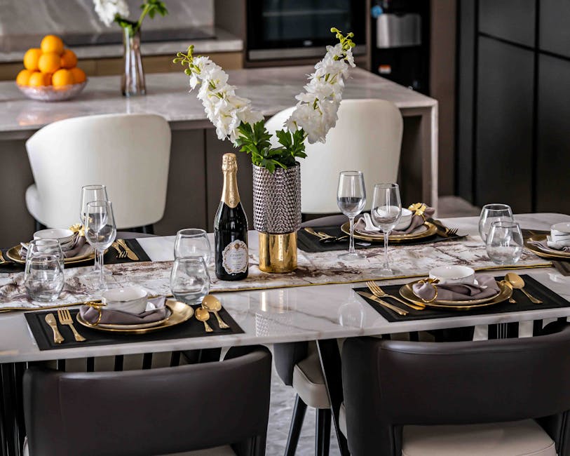 Luxurious dining table arrangement with elegant decor and floral centerpiece in a modern home.