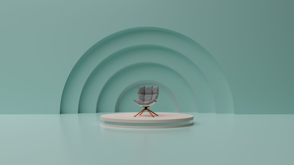 Modern minimalist design featuring a gray chair on a circular stage with abstract teal arcs.