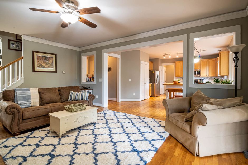 Spacious living room with modern decor and cozy seating arrangement.