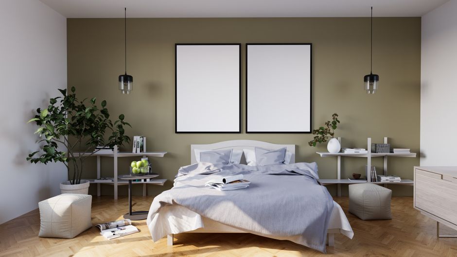 Elegant minimalist bedroom with green accent wall, plants, and modern furniture design.