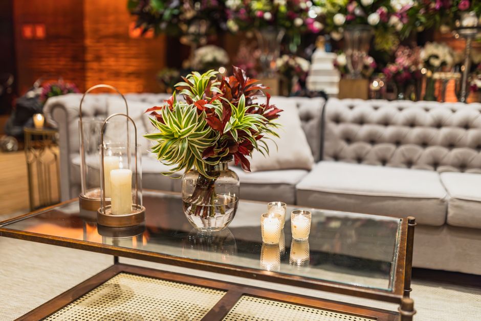 Luxurious living room featuring a glass table with stylish decor and a plush sofa.