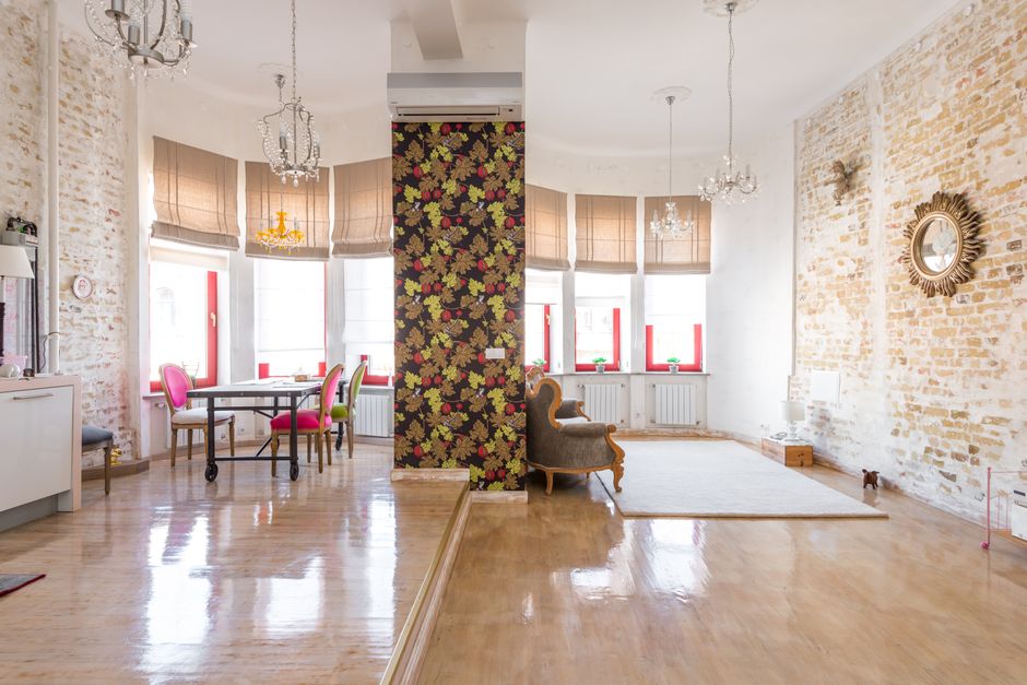 Modern open-plan living space with brick walls and elegant furnishings.