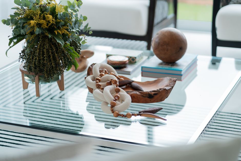 Sophisticated coffee table setup with rustic wood accents and vibrant plants, ideal for interior design inspiration.