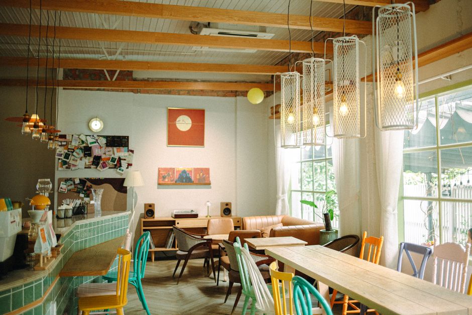 Warm and inviting cafe interior with eclectic furniture and vintage decor. Perfect for a leisurely coffee.