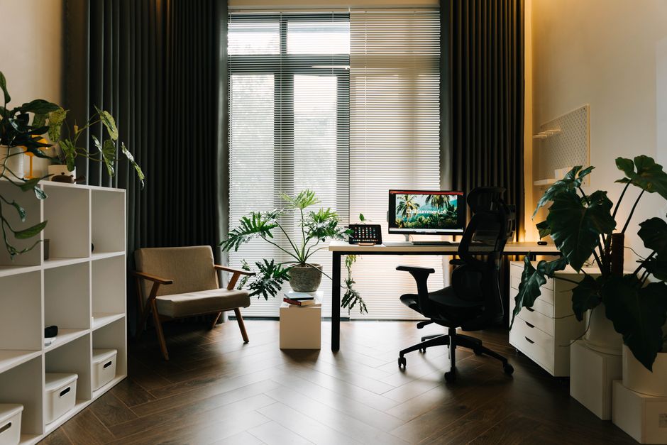 A stylish home office with modern furniture and lush greenery.