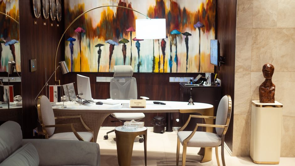 Elegant office reception featuring modern furniture and vibrant wall art in Baghdad.