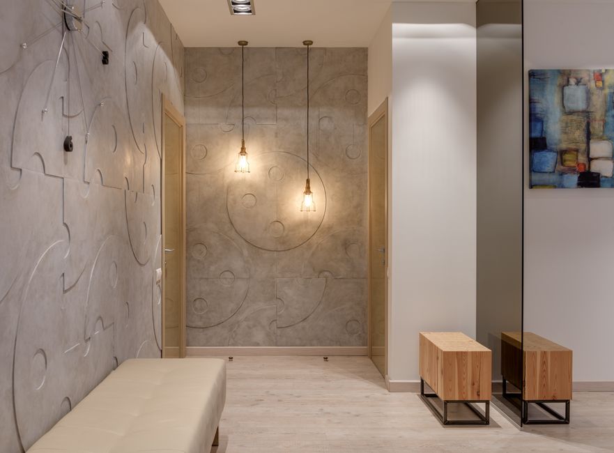 Interior of contemporary hall with textured walls and bright luminous lamps in comfortable flat