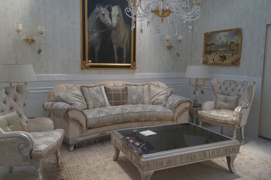 A sophisticated and luxurious living room interior featuring classic furniture and elegant decor.