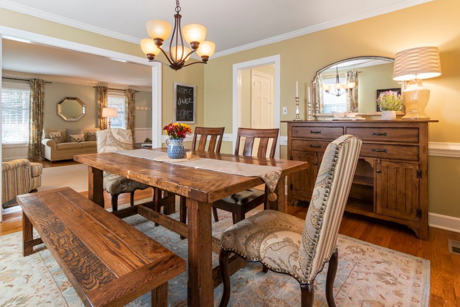 Warm dining room interior featuring rustic wooden furniture and classic decor elements.
